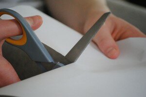 Hand holding scissors
